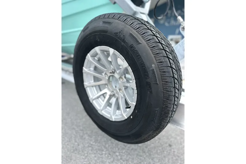 Slide: The Image of Close-up of a Pathfinder 2700 Tournament 2027 trailer tire on pavement. - 29