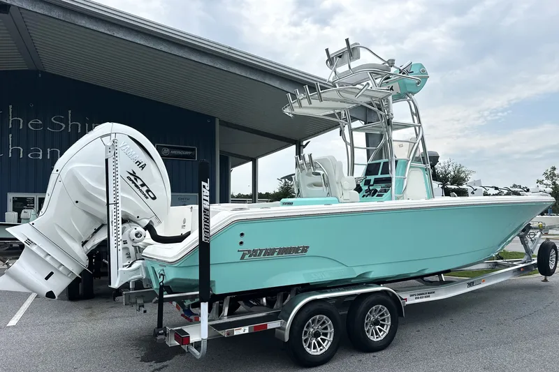 Slide: The Image of 2027 Pathfinder 2700 Tournament boat on trailer, featuring Yamaha engine, parked outdoors. - 28