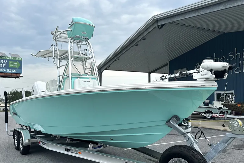 Slide: The Image of 2027 Pathfinder 2700 Tournament boat on trailer, mint green hull, Garmin equipment, outdoor display. - 1