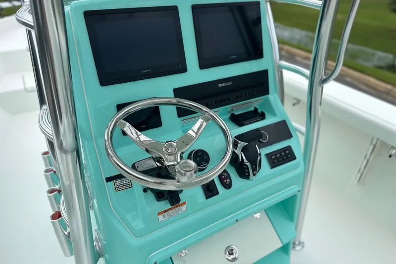 Slide: The Image of Steering console of 2027 Pathfinder 2700 Tournament boat with dual screens and controls. - 3