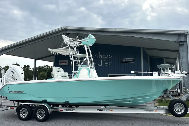 Slide: The Image of 2027 Pathfinder 2700 Tournament boat on trailer, displayed outside dealership. - 2
