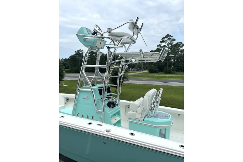 Slide: The Image of 2027 Pathfinder 2700 Tournament boat with elevated helm and seating, set against a scenic backdrop. - 21