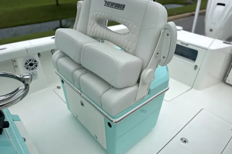 Slide: The Image of 2027 Pathfinder 2700 Tournament boat with white cushioned seating and teal accents. - 8