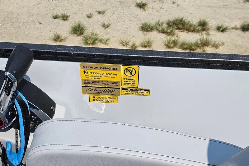 Slide: The Image of 2026 Bentley Pontoons 253 Elite Swingback DC capacity warning label on boat interior. - 19
