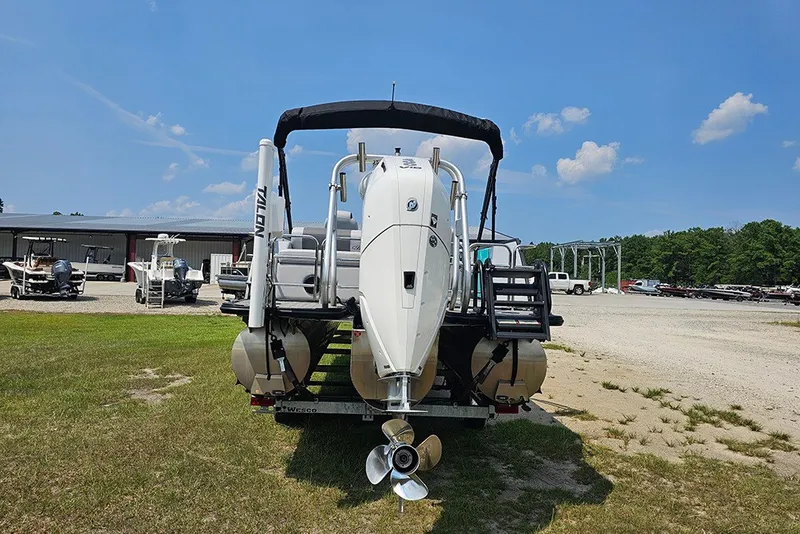 Slide: The Image of 2026 Bentley Pontoons 253 Elite Swingback DC, rear view, parked outdoors on grass. - 8