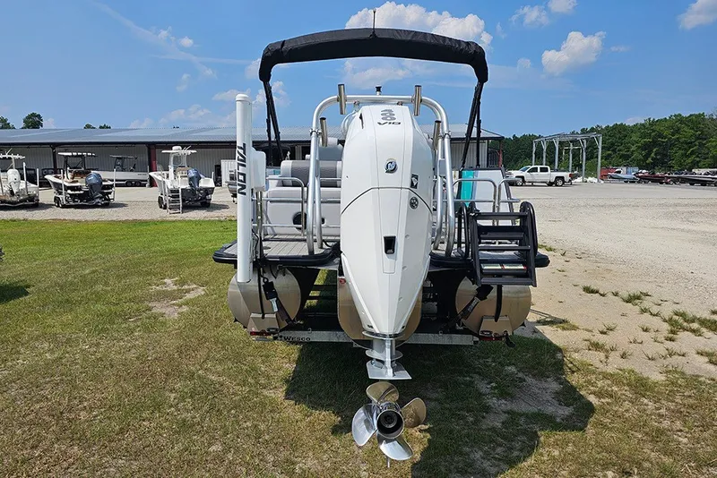 Slide: The Image of 2026 Bentley Pontoons 253 Elite Swingback DC with powerful outboard motor, parked outdoors. - 9