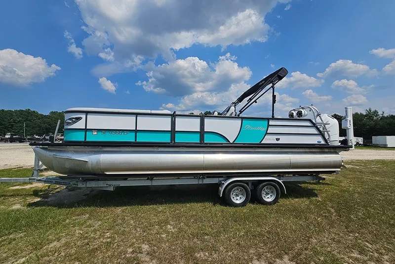 Slide: The Image of 2026 Bentley Pontoons 253 Elite Swingback DC on trailer under blue sky. - 6