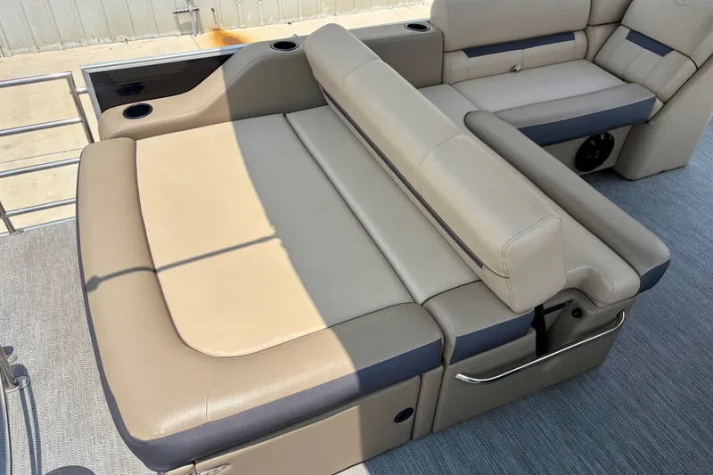 Slide: The Image of Luxurious seating on 2023 Sweetwater 2286 FSL pontoon boat, featuring beige upholstery and cup holders. - 23