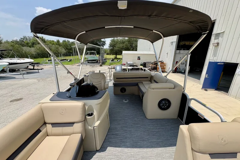 Slide: The Image of 2023 Sweetwater 2286 FSL pontoon boat with spacious seating and canopy in a marina setting. - 18