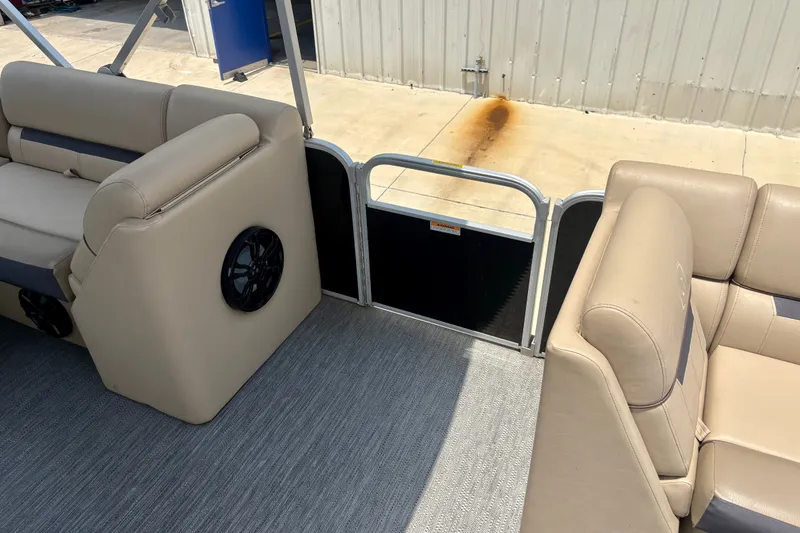 Slide: The Image of Interior of 2023 Sweetwater 2286 FSL pontoon boat with beige seating and speaker. - 36