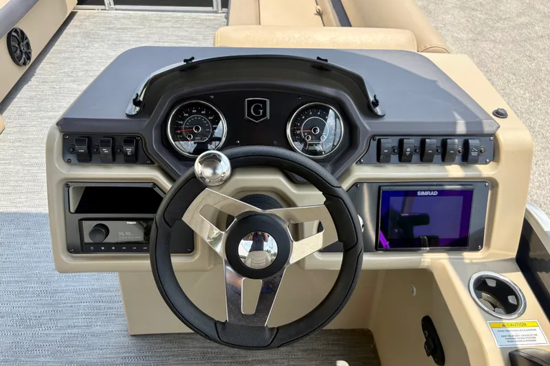Slide: The Image of 2023 Sweetwater 2286 FSL boat dashboard with steering wheel and control panel. - 31
