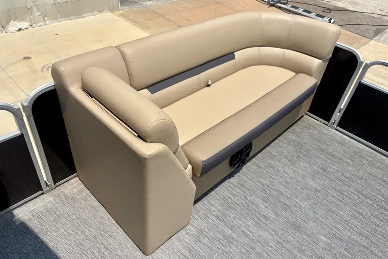 Slide: The Image of 2023 Sweetwater 2286 FSL boat interior with beige seating and gray flooring. - 28