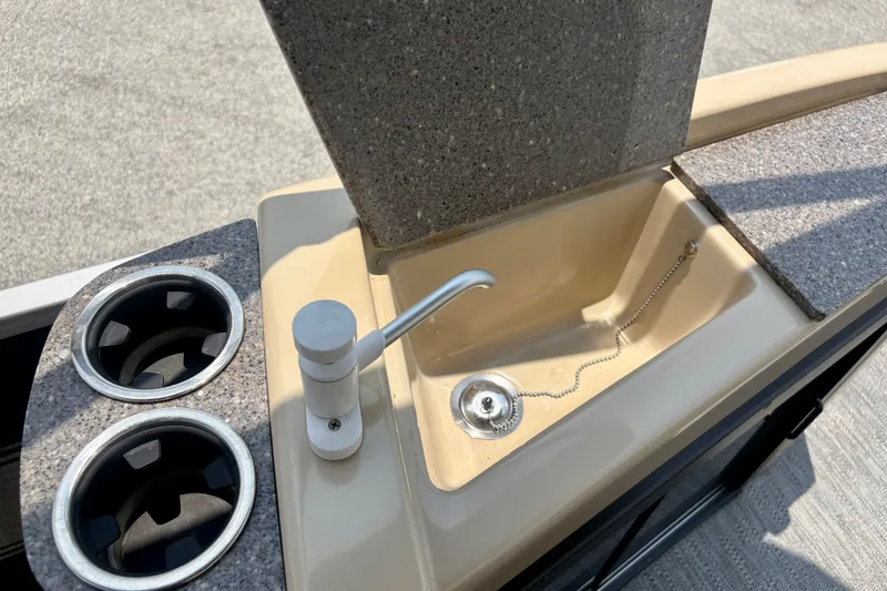 Slide: The Image of 2023 Sweetwater 2286 FSL boat sink with faucet and cup holders. - 26