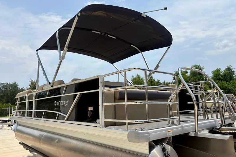 Slide: The Image of 2023 Sweetwater 2286 FSL pontoon boat with canopy, docked outdoors. - 12