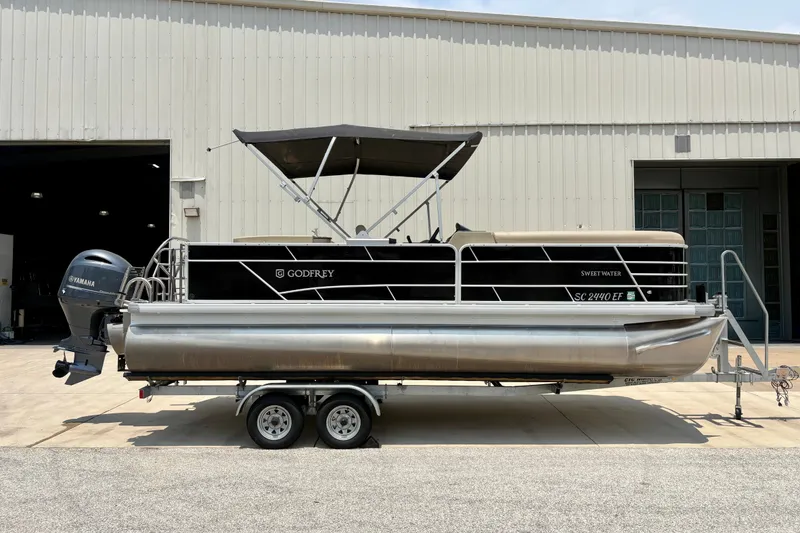 Slide: The Image of 2023 Sweetwater 2286 FSL pontoon boat with Yamaha motor, parked on a trailer. - 1