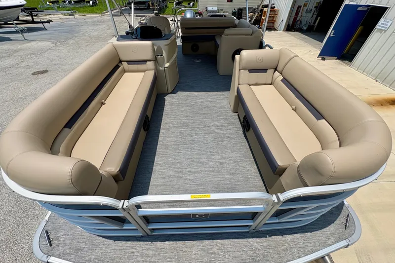 Slide: The Image of 2023 Sweetwater 2286 FSL pontoon boat with beige seating and spacious deck layout. - 16