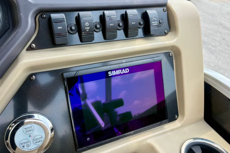 Slide: The Image of Dashboard of 2023 Sweetwater 2286 FSL with Simrad display and control switches. - 34