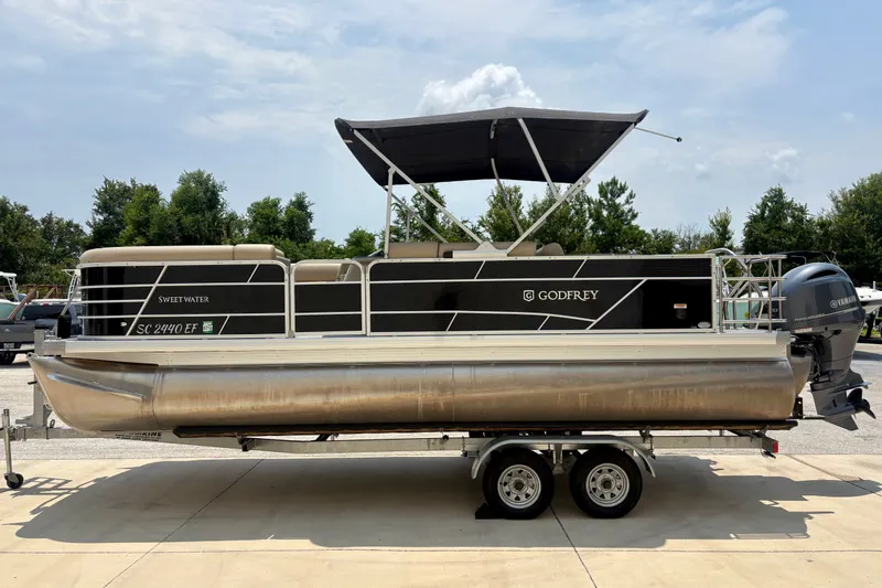 Slide: The Image of 2023 Sweetwater 2286 FSL pontoon boat with canopy and Yamaha motor on trailer. - 5