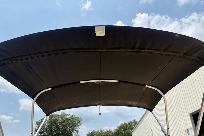 Slide: The Image of 2023 Sweetwater 2286 FSL boat canopy against a blue sky background. - 39