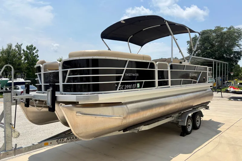 Slide: The Image of 2023 Sweetwater 2286 FSL pontoon boat on trailer, parked outdoors. - 4