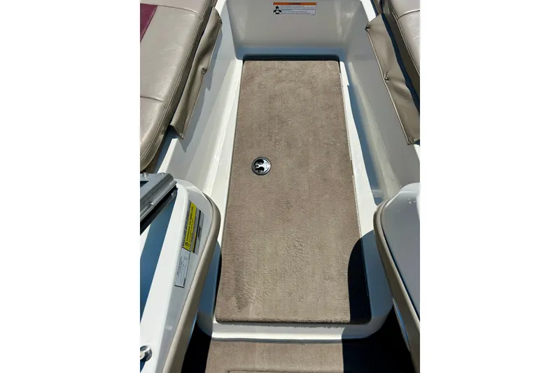 Slide: The Image of 2006 Ranger 180 Reata boat interior with beige carpet and seating. - 28