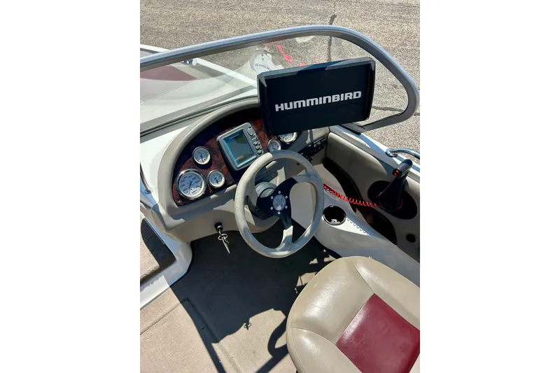 Slide: The Image of 2006 Ranger 180 Reata boat dashboard with Humminbird fish finder and steering wheel. - 32