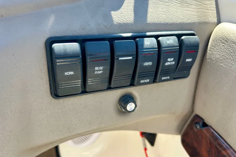 Slide: The Image of Control panel of a 2006 Ranger 180 Reata boat with labeled switches. - 34