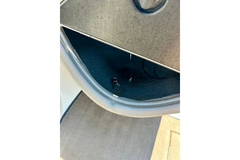 Slide: The Image of 2006 Ranger 180 Reata boat interior storage compartment with carpeted floor. - 31