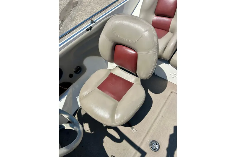 Slide: The Image of 2006 Ranger 180 Reata boat seat with beige and maroon upholstery. - 24