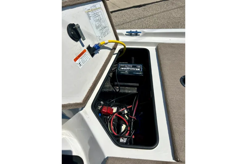 Slide: The Image of Open battery compartment of 2006 Ranger 180 Reata boat with visible wiring and connections. - 46