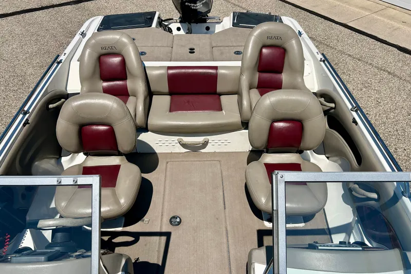 Slide: The Image of 2006 Ranger 180 Reata boat interior with beige and red seating arrangement. - 23