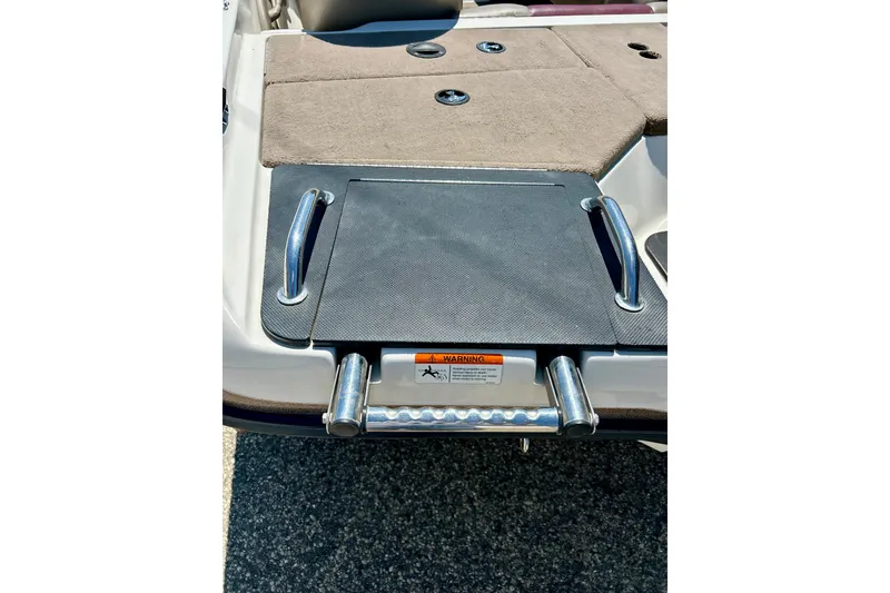 Slide: The Image of 2006 Ranger 180 Reata boat swim platform with ladder and safety warning label. - 48