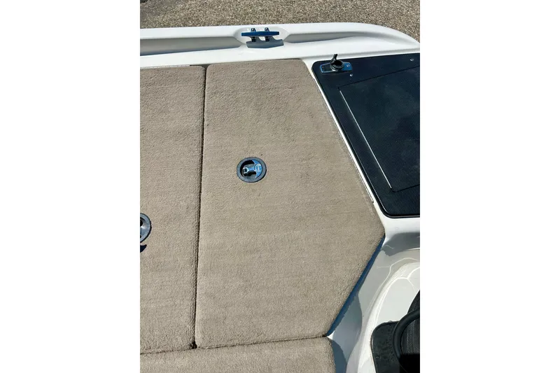 Slide: The Image of 2006 Ranger 180 Reata boat deck with beige carpet and storage compartments. - 41