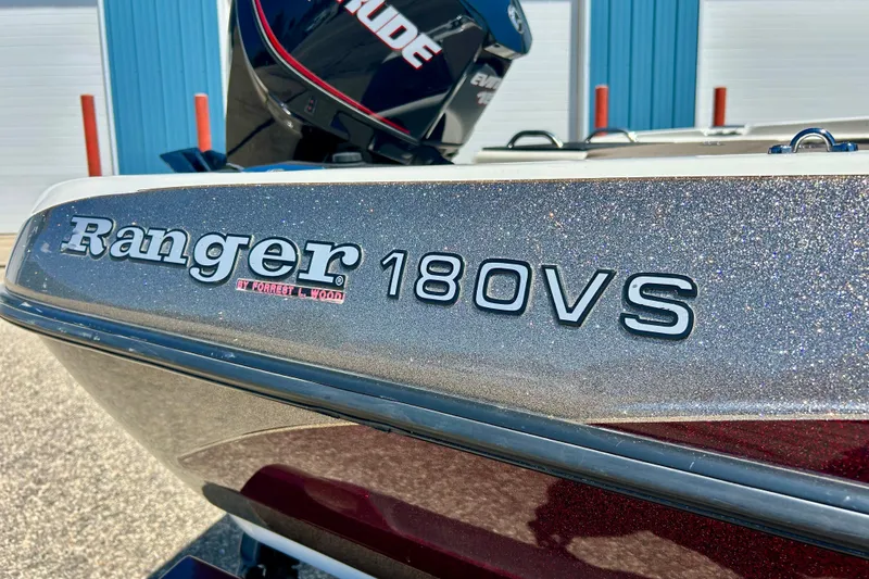 Slide: The Image of 2006 Ranger 180 Reata boat with metallic finish, parked outdoors. - 12