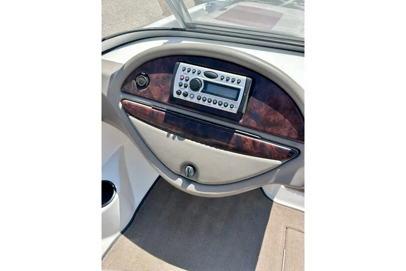 Slide: The Image of Dashboard of a 2006 Ranger 180 Reata boat with wood paneling and stereo system. - 30