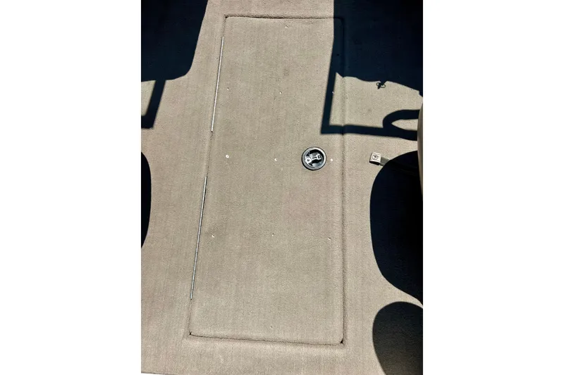 Slide: The Image of Carpeted deck of a 2006 Ranger 180 Reata boat, featuring a hatch and latch. - 35