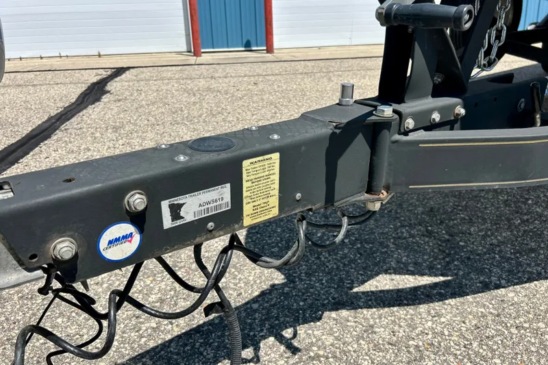 Slide: The Image of Trailer hitch of a 2006 Ranger 180 Reata boat, featuring registration and certification labels. - 55