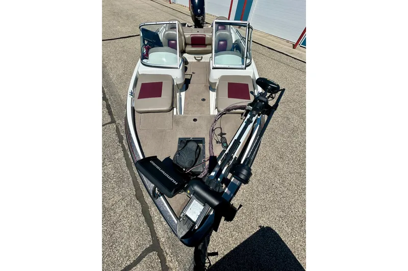 Slide: The Image of 2006 Ranger 180 Reata boat with dual windshields and trolling motor on a sunny day. - 6