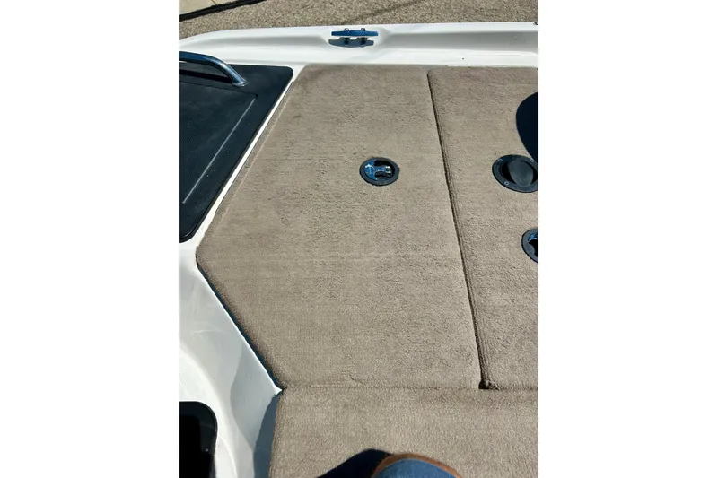 Slide: The Image of 2006 Ranger 180 Reata boat deck with beige carpet and metal fittings. - 45