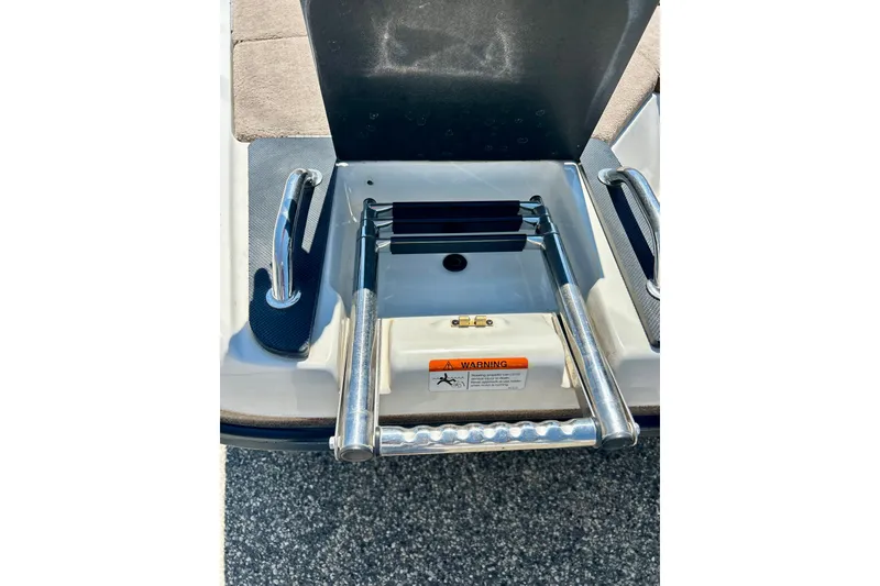 Slide: The Image of 2006 Ranger 180 Reata boat ladder with safety warning label. - 49