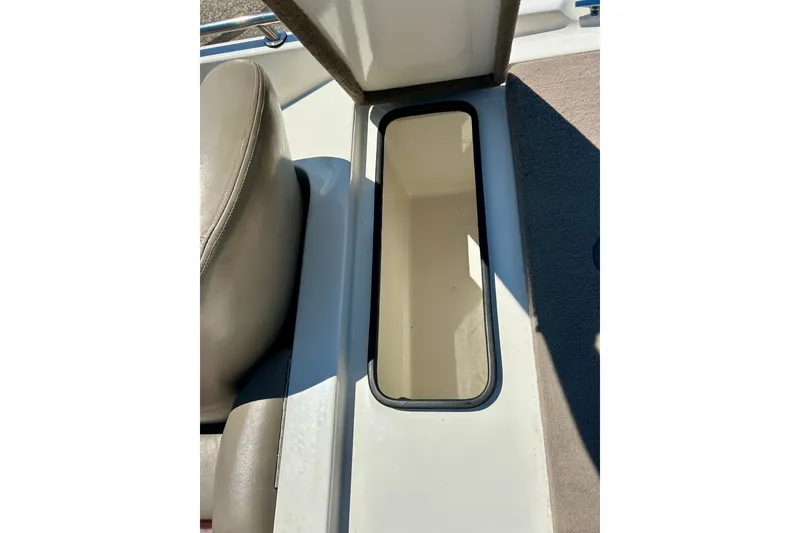 Slide: The Image of Storage compartment in 2006 Ranger 180 Reata boat, featuring beige interior and seating. - 40