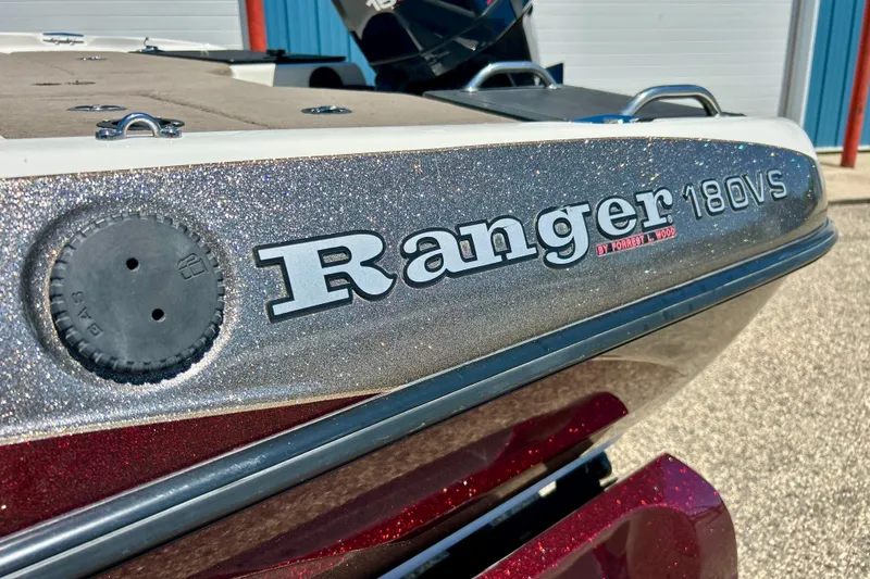 Slide: The Image of 2006 Ranger 180 Reata boat with glittery finish, close-up view of branding. - 10