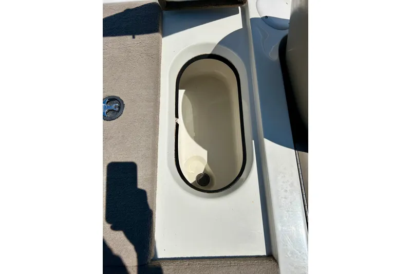 Slide: The Image of 2006 Ranger 180 Reata boat compartment with beige carpet and white interior. - 44