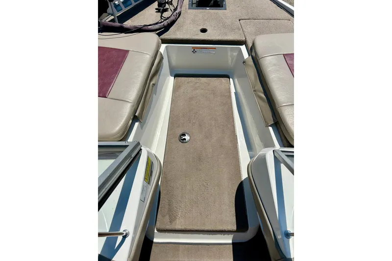 Slide: The Image of 2006 Ranger 180 Reata boat interior with beige seating and carpeted flooring. - 16