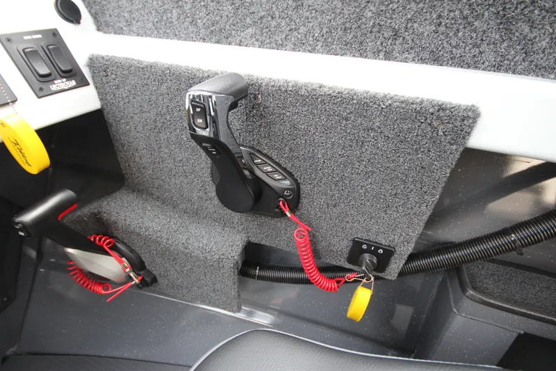 Slide: The Image of Control panel of 2027 Weldcraft 240 Maverick DV boat with throttle and switches. - 25