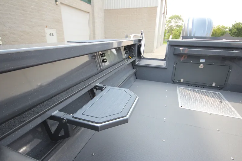 Slide: The Image of 2027 Weldcraft 240 Maverick DV boat interior with foldable table and storage compartment. - 15