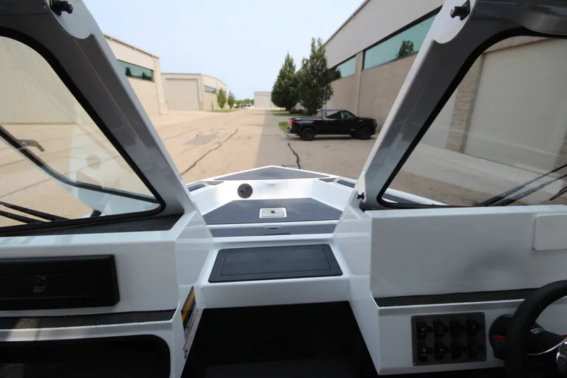 Slide: The Image of Interior view of 2027 Weldcraft 240 Maverick DV boat, showcasing dashboard and windshield. - 28