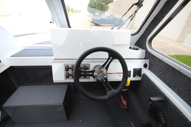 Slide: The Image of Interior view of 2027 Weldcraft 240 Maverick DV boat cockpit with steering wheel. - 24