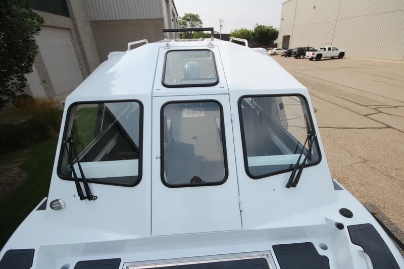 Slide: The Image of 2027 Weldcraft 240 Maverick DV boat with sleek cabin design and dual windshield wipers. - 31
