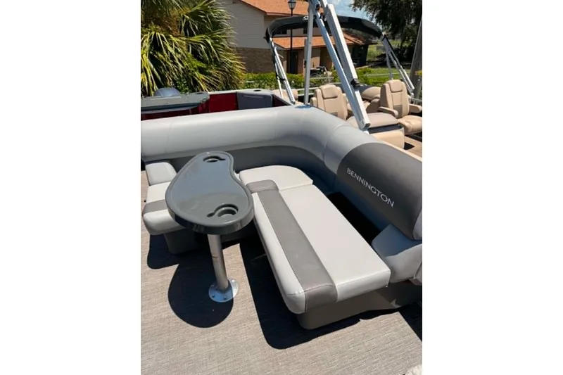 Slide: The Image of 2024 Bennington SV 20 pontoon boat interior with gray seating and table. - 6